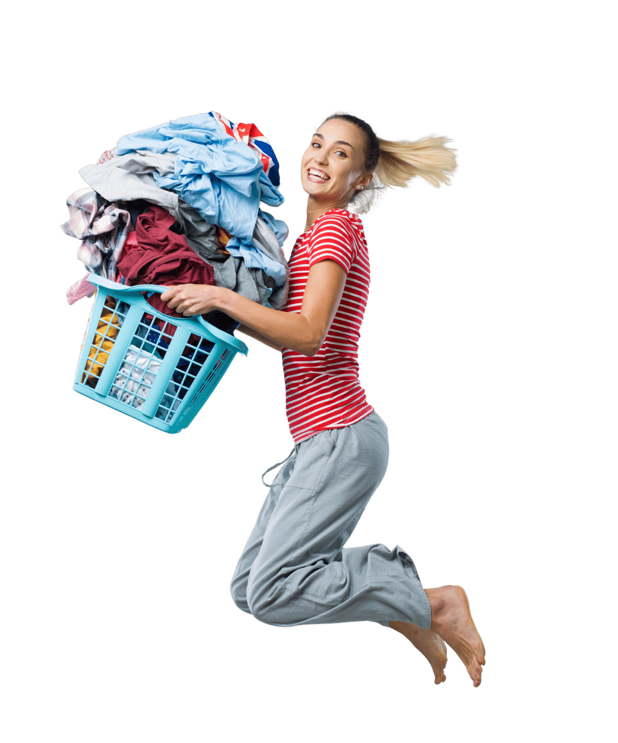 Woman in pajamas with laundry basket jumping in the air smiling